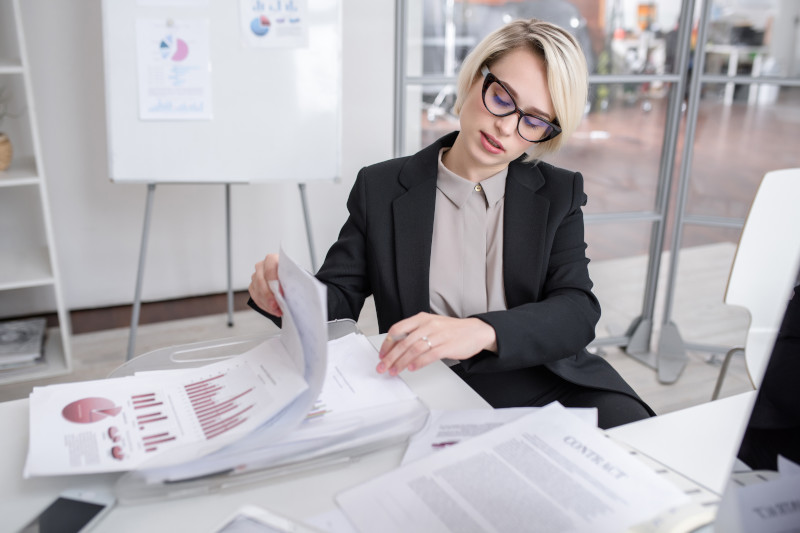 female marketing professional examining company documents